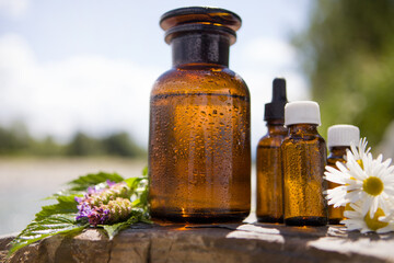 Spa wellness set - bottles of essential oils on the rock.