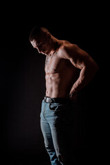 Fototapeta na wymiar Young muscular guy in the studio, posing for the camera