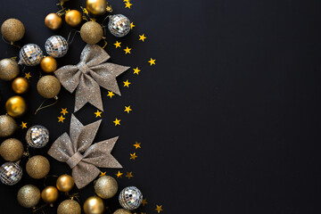 Christmas golden silver decoration balls on black background. Flat lay and Copy Space. Merry Christmas and Happy New Year.