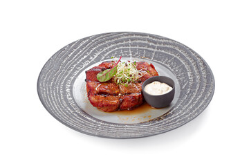 Grilled beef steak on grey plate isolated on white