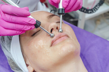 Microcurrent therapy for woman's face in spa beauty salon.