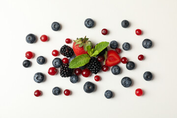 Mix of fresh berries on white background, top view