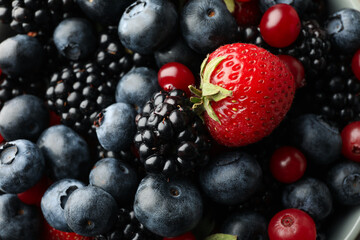 Mix of fresh berries on whole background, close up