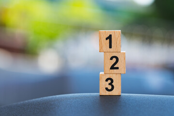 Wooden block number on blurry background using as business competition concept