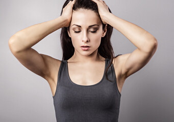Naklejka premium Depressed woman holding the hand the head. Cold, flu, virus, tonsillitis, respiratory disease, quarantine, epidemic concept portrait. Beautiful caucasian young woman. Closeup