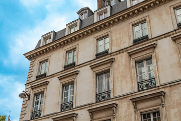 Typical old Paris architecture, facades of residential buildings with balconies and mansards
