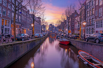 Fototapeta premium City scenic from Amsterdam at the Oude Zijdsvoorburgwal in the Netherlands at sunset