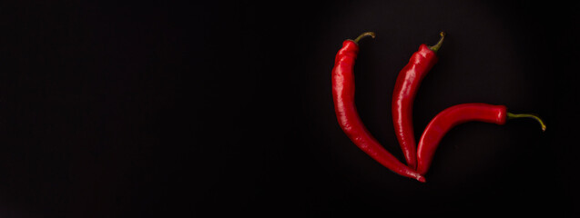 Obraz premium Three red hot chili peppers combined together.