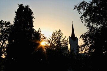 Church at sunset with silhouette of trees