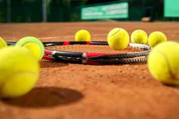 Racket and scattered tennis balls on the court