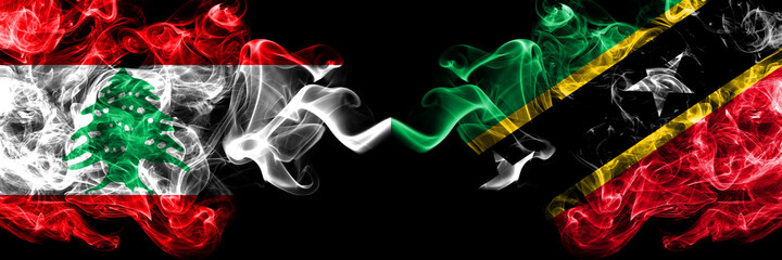 Lebanon vs Saint Kitts and Nevis smoky mystic flags placed side by side. Thick colored silky abstract smoke flags.