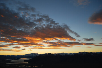 Fototapeta na wymiar Dramatic sky cluds. Orange lenticular cluds. Sunset. South Patagonian sky.