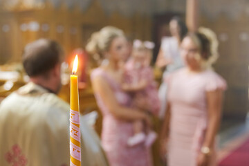 Burning candle at Orthodox christening with blurred background