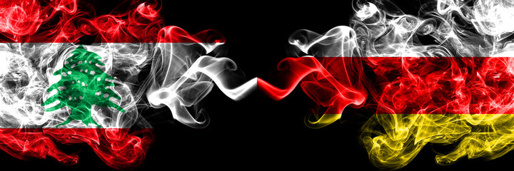 Lebanon vs South Ossetia smoky mystic flags placed side by side. Thick colored silky abstract smoke flags.