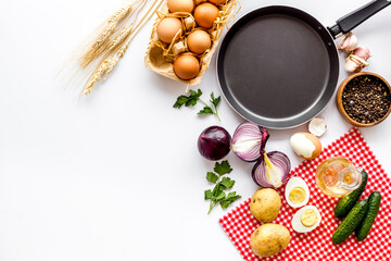 Above view of country dinner table with effs, bread, potatoes