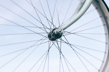 Close-up of a bicycle wheel on a blue sky