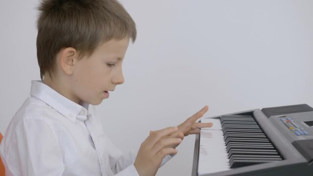 Child learning to play at piano, easy and patience process, love music