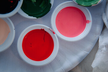 Water colour of paint on mini paper dish. Concept of learning by doing