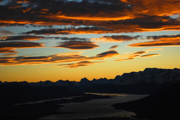 Dramatic sky cluds. Orange lenticular cluds. Sunset. South Patagonian sky.
