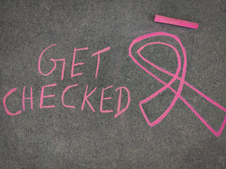Fototapeta na wymiar Chalk drawing of Breast Cancer Awareness Ribbon and inscription text 