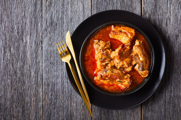 Braised Pork pieces in a black bowl