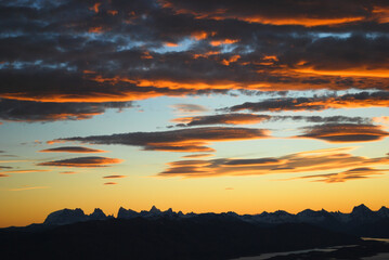 Obraz premium Dramatic sky cluds. Orange lenticular cluds. Sunset. South Patagonian sky.