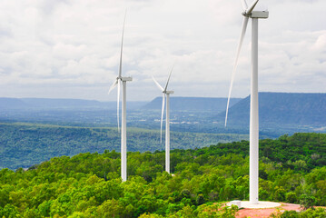 Windmill on a ridge with dense forest. Natural wind power, renewable energy, pure energy