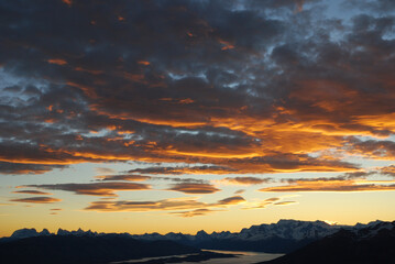 Obraz premium Dramatic sky cluds. Orange lenticular cluds. Sunset. South Patagonian sky.