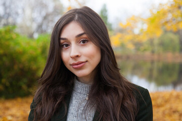 Portrait of walking young girl in autumn park