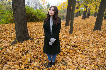 Portrait of walking young girl in autumn park