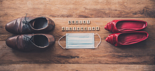 Men and women shoes laid on wooden floors, concept social distancing during the epidemic disease covid-19