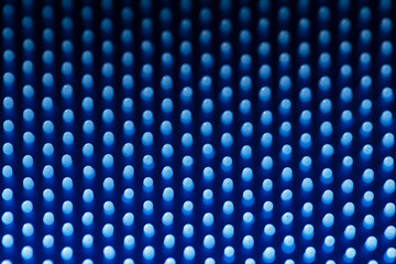 Macro detailed full-frame view of the thin bristles of a blue silicone dish scrubber, for scrubbing pots and pans