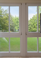 view of the window in the room on a green park on a sunny summer day