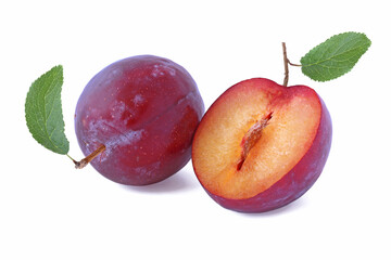 Whole plum and half with leaves isolated on a white