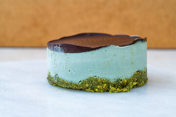 Vegan Raw Round Cheesecake with Mint, Bitter Chocolate and Pistachio Nut Paste.