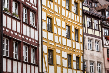 Detail of Half-timber work on the facade of wooden buildings in the German city of Nuremberg, Bavaria. German traditional architecture “Fachwerkhaus“ Timber framing Horizontal view
