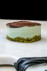 Vegan Raw Round Cheesecake with Mint, Bitter Chocolate and Pistachio Nut Paste.