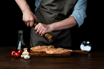 The cook poured oil on the chicken breast