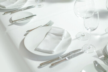 Place setting for one person. Knife, square glass plate and fork.