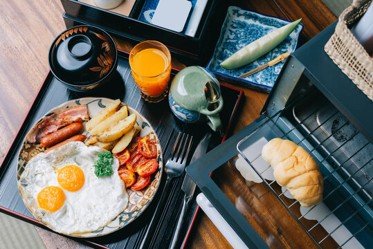Food series: American breakfast set on wooden table in ryokan, traditional Japanese hotel