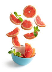 Fototapeta na wymiar Sliced blood red orange with mint leaves flying in a blue bowl, isolated from white background