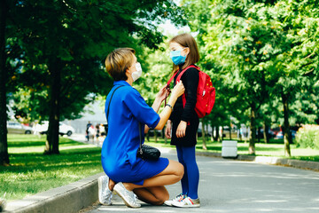 Back to school. Mother seeing off her child.