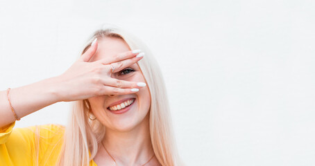 Obraz premium Happy woman looking between fingers