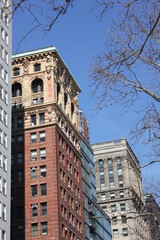 Obraz premium Brown apartment building with arched windows and facade ornaments