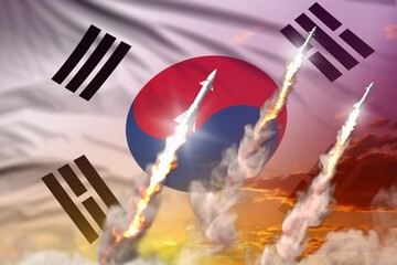 Modern strategic rocket forces concept on sunset background, Republic of Korea (South Korea) supersonic warhead attack - military industrial 3D illustration, nuke with flag
