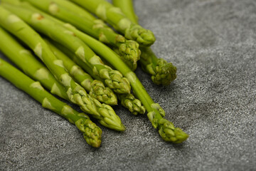 Fresh green asparagus on stone table surface