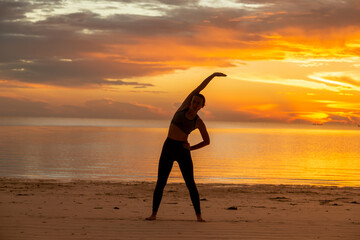 Woman stretching out on the beach