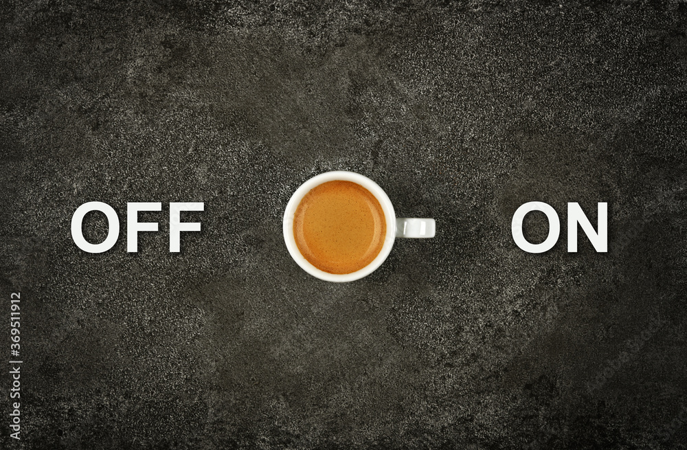 Wall mural Cup of espresso coffee and on off power switch