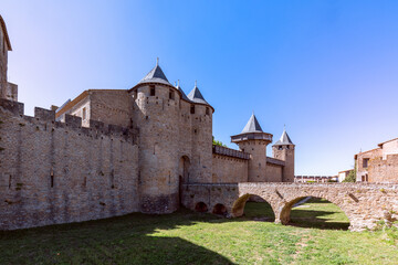 Fototapeta na wymiar The old bridge over the moat leading to the castle of Carcassonne town