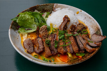 Peking duck curry with rice and salad